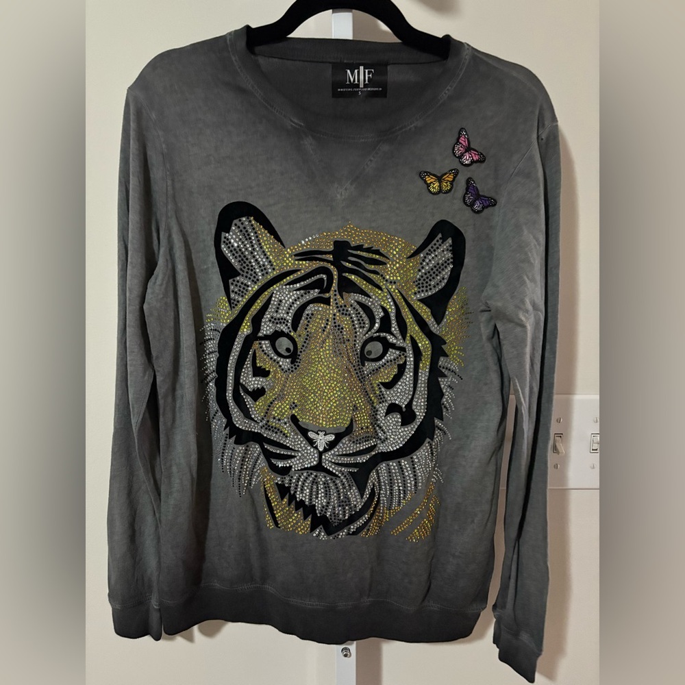 Gray tiger graphic sweatshirt with sequin and patch embellishments.